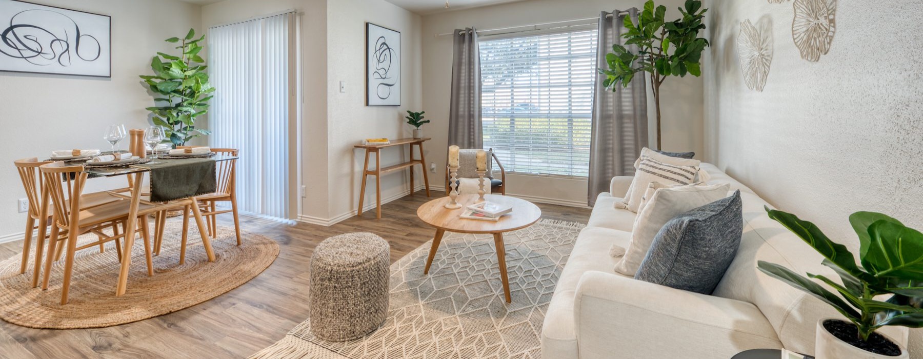 a living room with a couch, table and chairs
