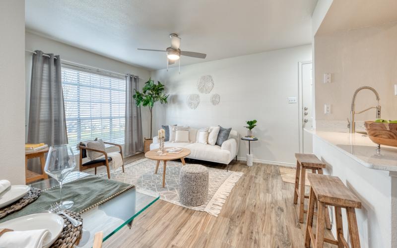 a living room with a couch, tables and chairs